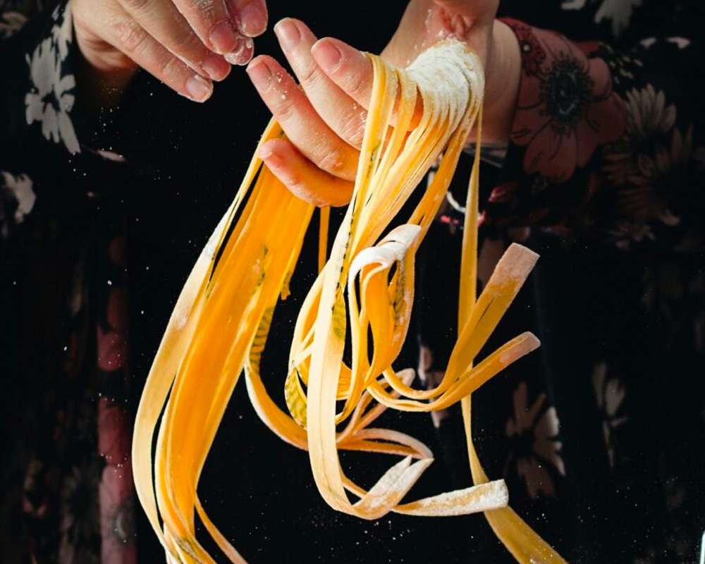 hands holding handmade noodles